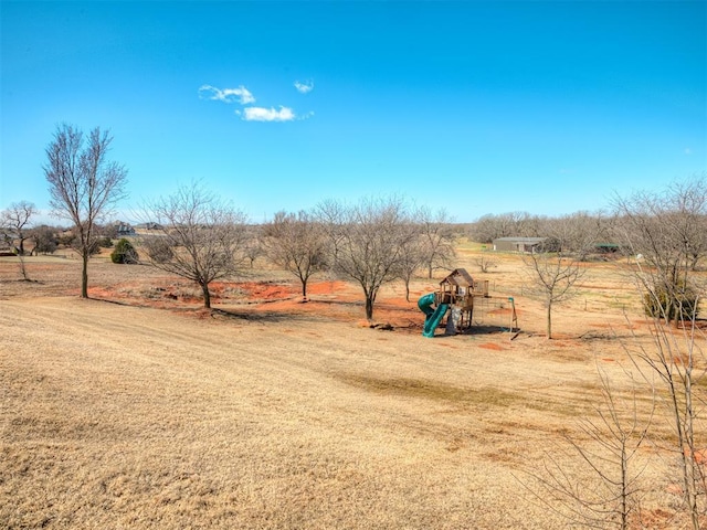 view of yard featuring a rural view and a playground
