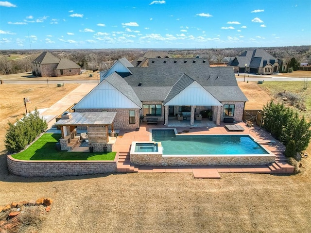 view of swimming pool with a fenced backyard, an outdoor living space, a patio area, a pool with connected hot tub, and a yard