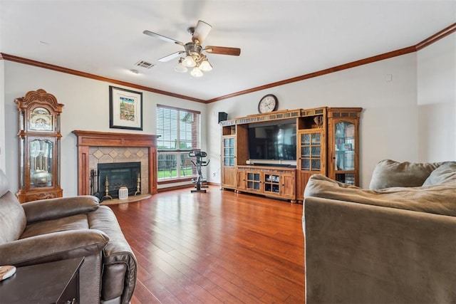 116 Mission Hills Dr, Guthrie, OK 73044 - living room featuring a ceiling fan, wood finished floors, a tile fireplace, and ornamental molding