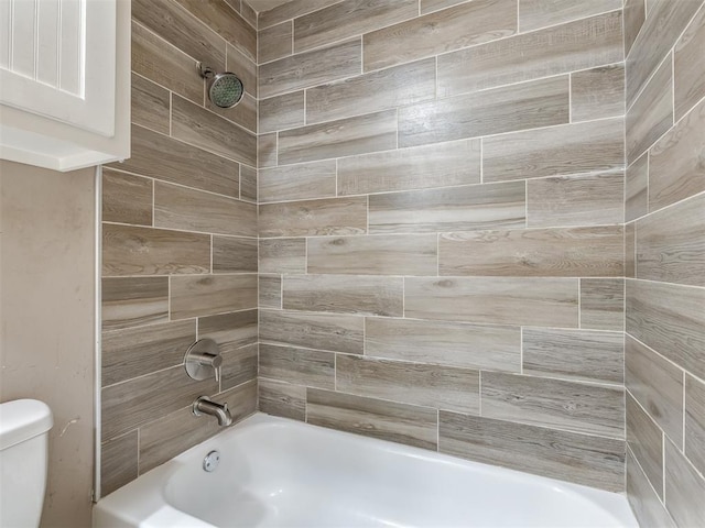 bathroom featuring washtub / shower combination and toilet