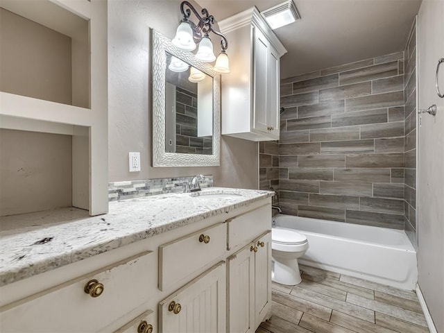 full bath with vanity, wood finish floors, toilet, and bathtub / shower combination