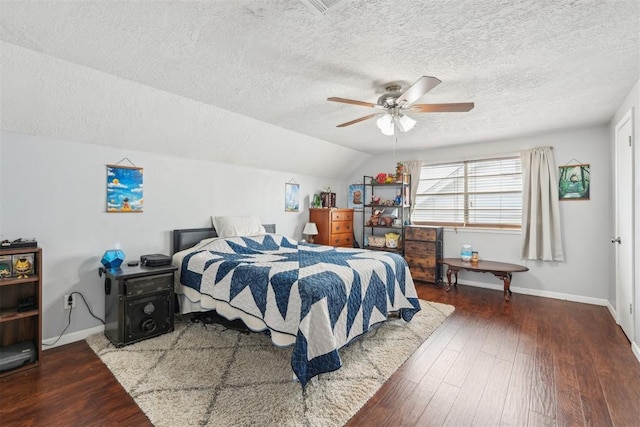 bedroom featuring baseboards, a ceiling fan, a textured ceiling, and wood finished floors
