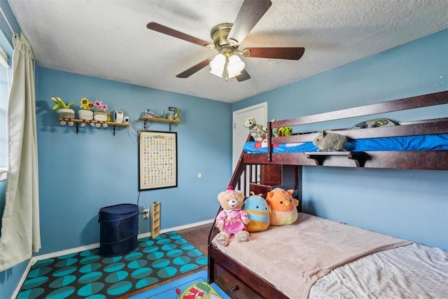 bedroom with baseboards, a textured ceiling, and ceiling fan