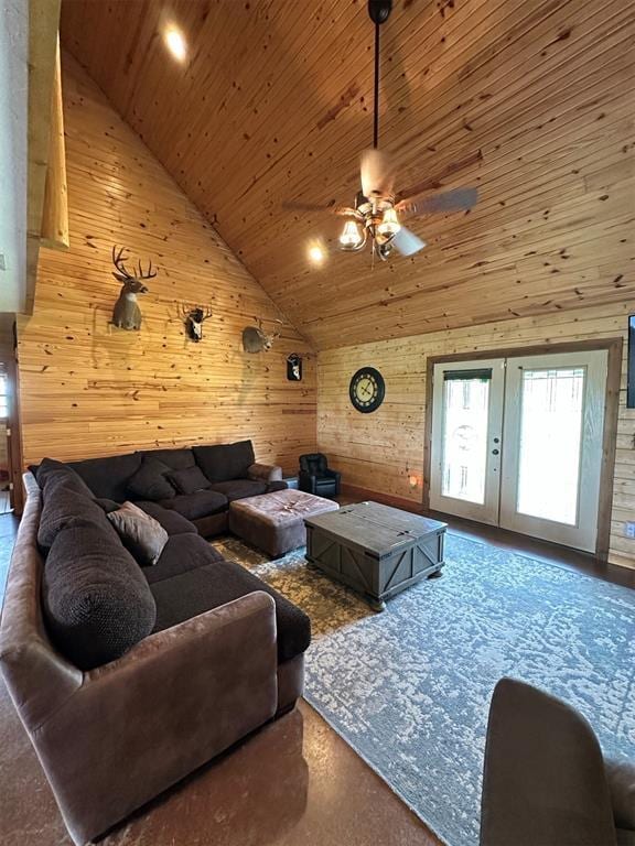 living room with wooden walls, wood ceiling, ceiling fan, and french doors