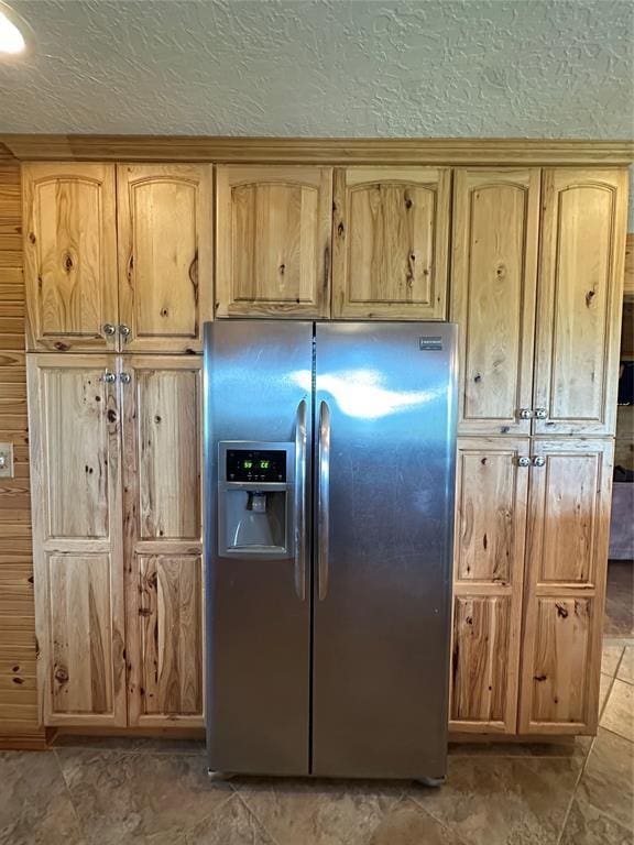 kitchen featuring stainless steel refrigerator with ice dispenser and a textured ceiling