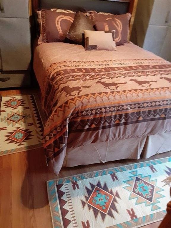 bedroom featuring wood finished floors