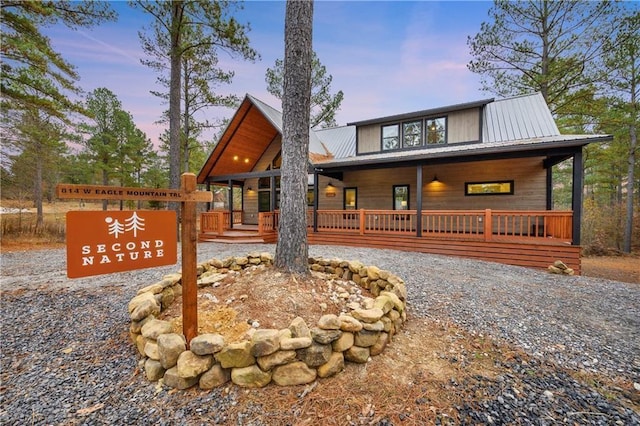 chalet / cabin with metal roof and covered porch