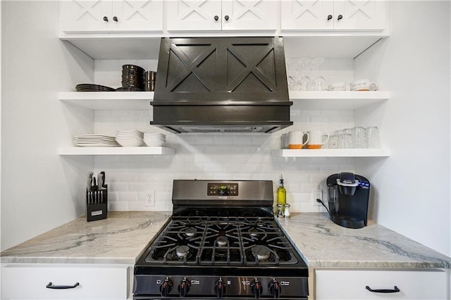 kitchen with open shelves, white cabinetry, gas stove, and custom range hood
