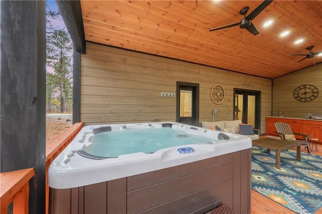 wooden deck featuring a hot tub and ceiling fan