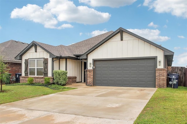 view of front of property with brick siding, a front lawn, roof with shingles, and a garage