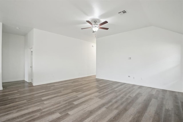 unfurnished living room featuring visible vents, a ceiling fan, baseboards, and wood finished floors