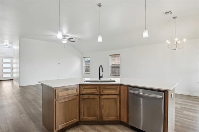 kitchen featuring stainless steel dishwasher, a sink, a wealth of natural light, and open floor plan