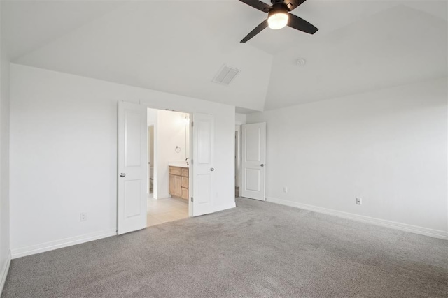 unfurnished bedroom featuring visible vents, baseboards, lofted ceiling, and light carpet