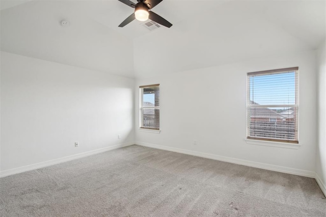 carpeted empty room with baseboards, a ceiling fan, lofted ceiling, and visible vents