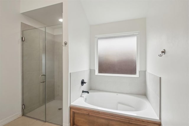 full bathroom featuring a shower stall and a bath