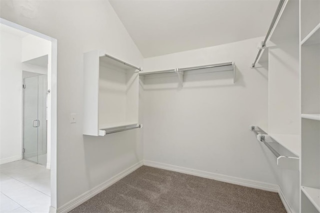 walk in closet with vaulted ceiling