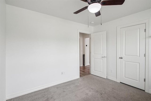 unfurnished bedroom with baseboards, ceiling fan, and carpet