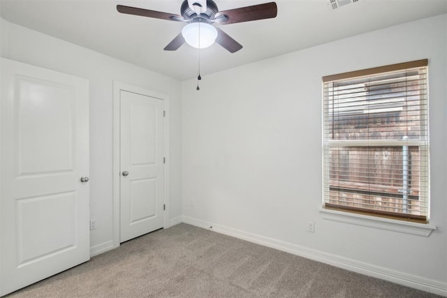 unfurnished bedroom with baseboards, ceiling fan, light carpet, and visible vents