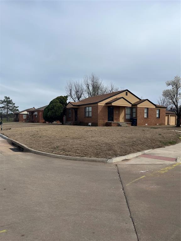 ranch-style home featuring brick siding