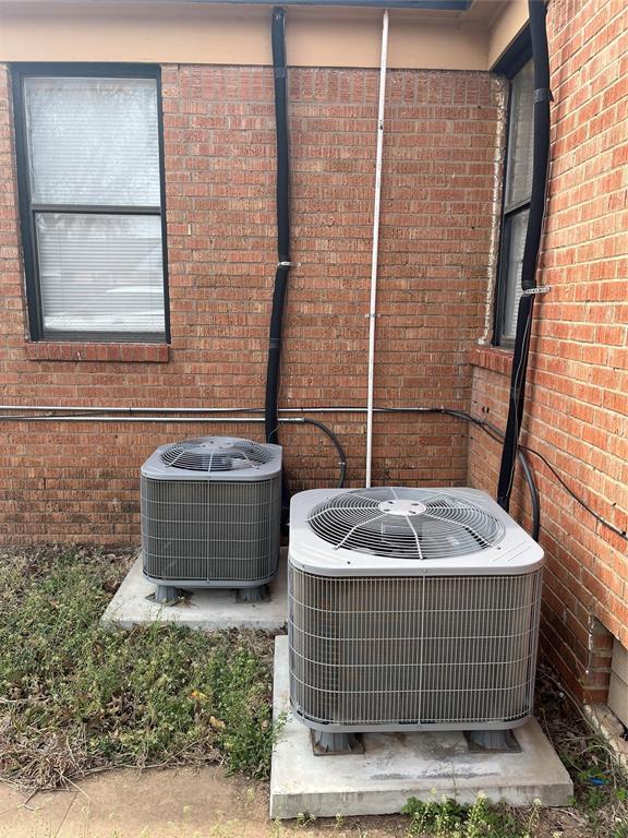 exterior details with brick siding and central AC