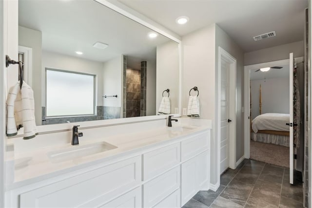 ensuite bathroom with a sink, ensuite bath, double vanity, and visible vents