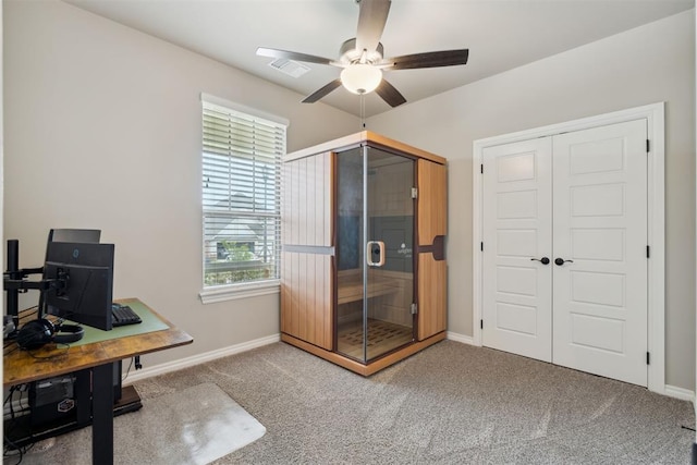 carpeted home office featuring a ceiling fan, baseboards, and visible vents