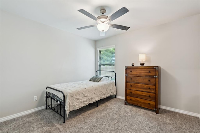 carpeted bedroom featuring baseboards and ceiling fan