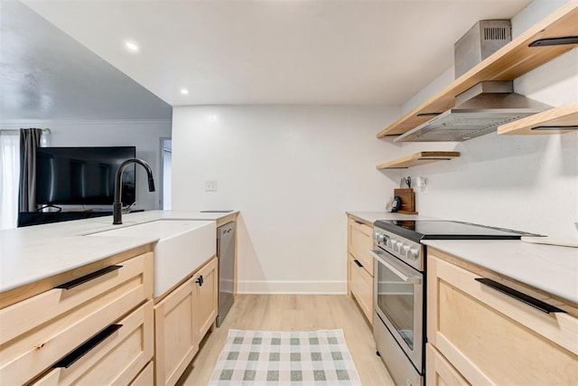 kitchen with open shelves, light wood-type flooring, light countertops, stainless steel appliances, and wall chimney exhaust hood