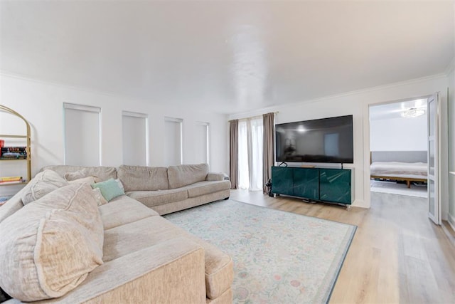 living room featuring crown molding and wood finished floors