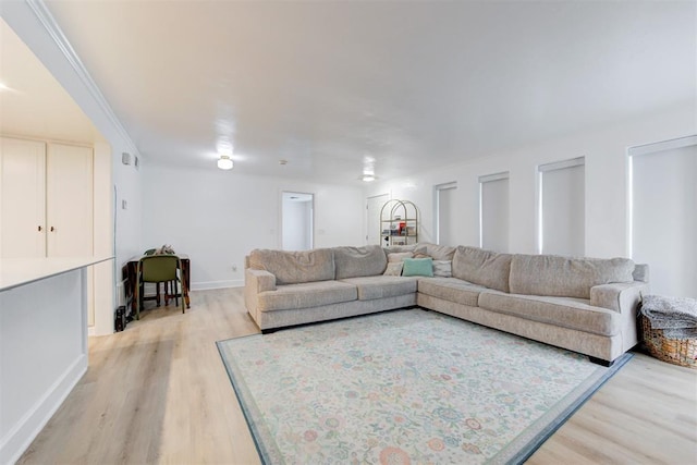 living room featuring baseboards and light wood-type flooring