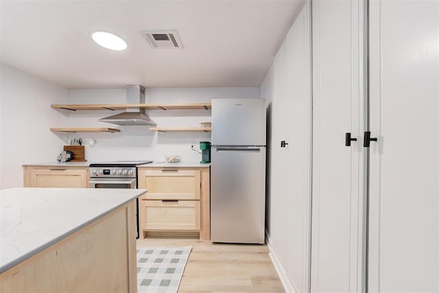 kitchen featuring wall chimney range hood, stainless steel appliances, open shelves, and light brown cabinets
