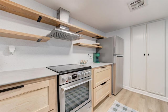 kitchen featuring visible vents, open shelves, light countertops, stainless steel appliances, and light wood-style flooring