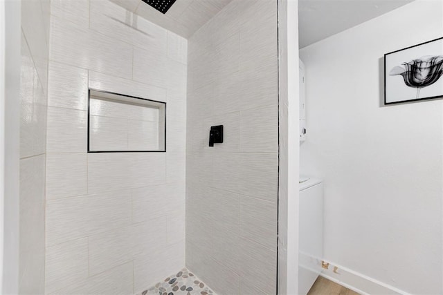 bathroom featuring toilet and tiled shower