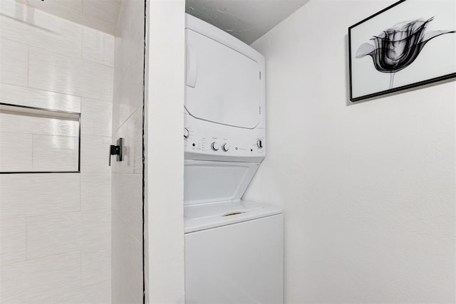 laundry room featuring laundry area and stacked washer / drying machine