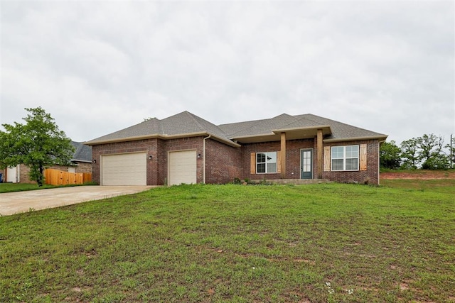 view of front of house featuring fence, a front yard, brick siding, an attached garage, and driveway