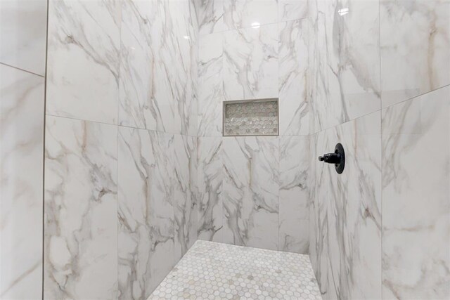 full bath featuring a marble finish shower
