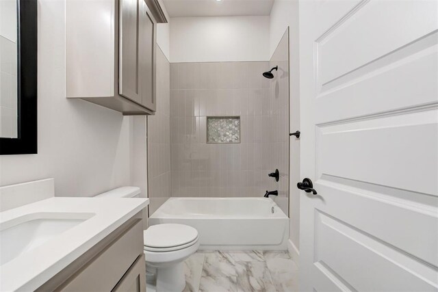full bath with vanity, marble finish floor, bathing tub / shower combination, and toilet