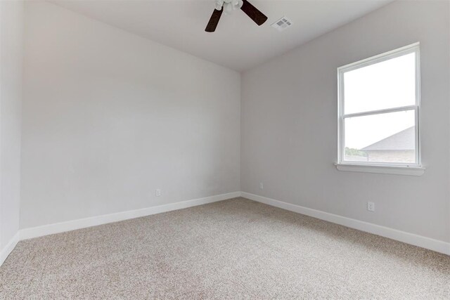 carpeted empty room with a healthy amount of sunlight, baseboards, and ceiling fan