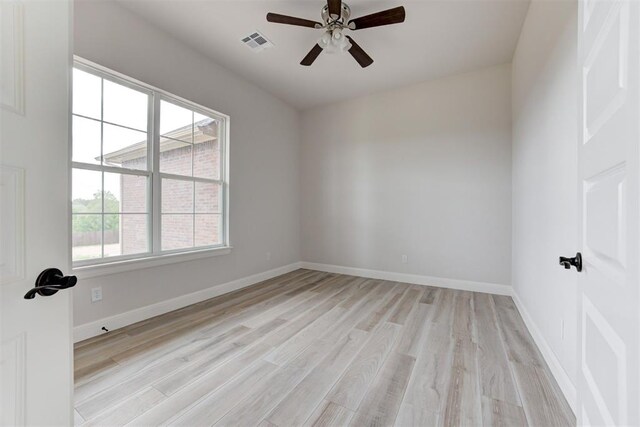 spare room with a ceiling fan, baseboards, visible vents, and light wood-type flooring