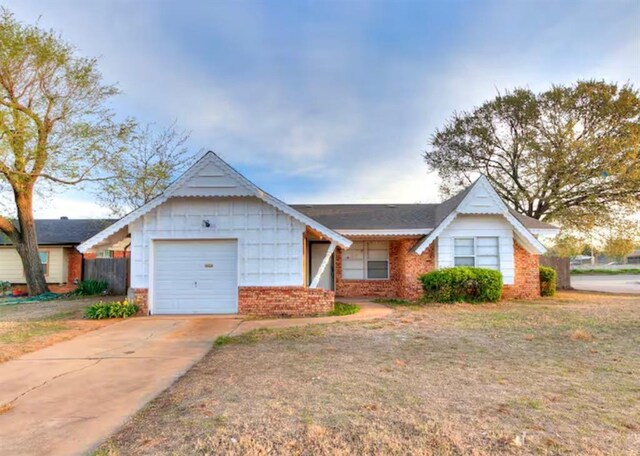 view of front of house with concrete driveway, brick siding, and an attached garage