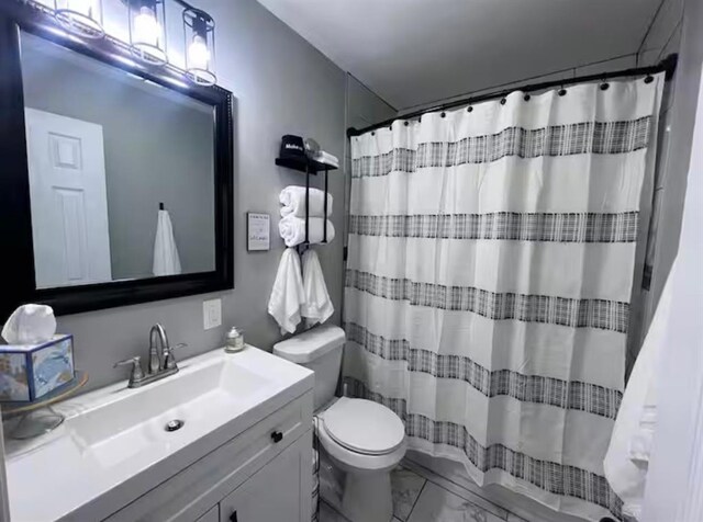 full bath featuring toilet, a shower with curtain, marble finish floor, and vanity