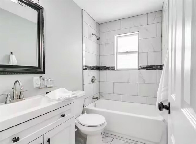 bathroom with toilet, shower / bathing tub combination, marble finish floor, and vanity