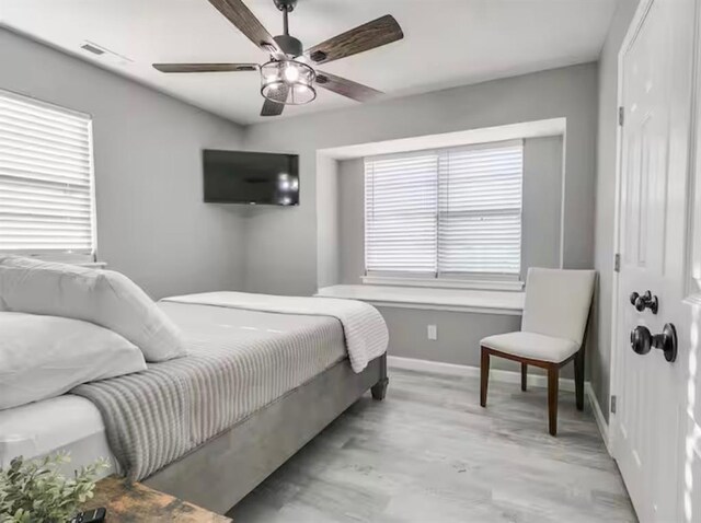 bedroom featuring baseboards, visible vents, and ceiling fan
