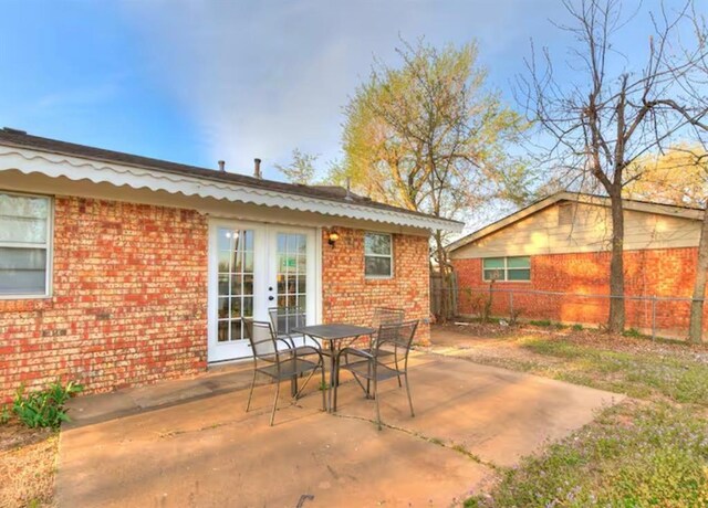 view of patio / terrace with fence, outdoor dining area, and french doors