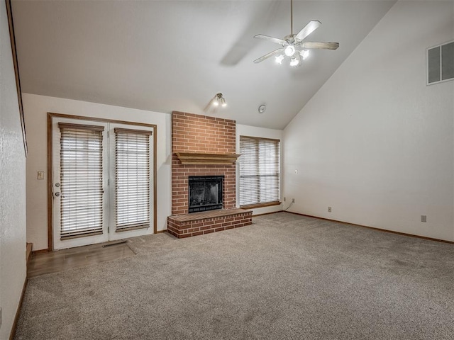 unfurnished living room featuring ceiling fan, visible vents, a brick fireplace, carpet floors, and lofted ceiling