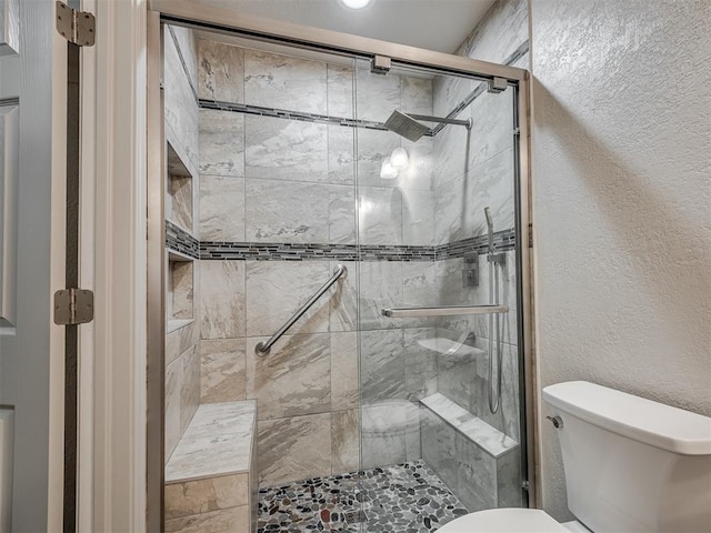 full bath with toilet and a stall shower