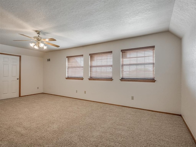 unfurnished bedroom with light colored carpet, a textured ceiling, baseboards, and visible vents