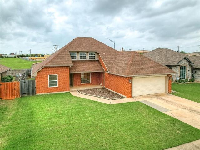 view of front facade featuring fence, an attached garage, a shingled roof, and brick siding