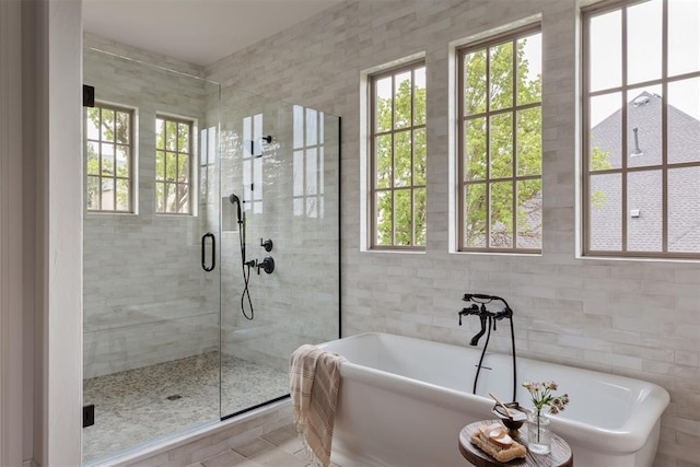 6509 NE 97th St, Oklahoma City, OK 73151 - full bathroom featuring plenty of natural light, tile walls, a shower stall, and a freestanding tub