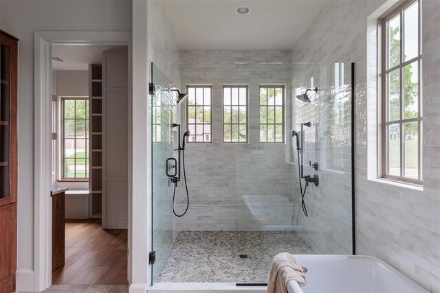 6509 NE 97th St, Oklahoma City, OK 73151 - full bath with a walk in shower, a garden tub, and wood finished floors